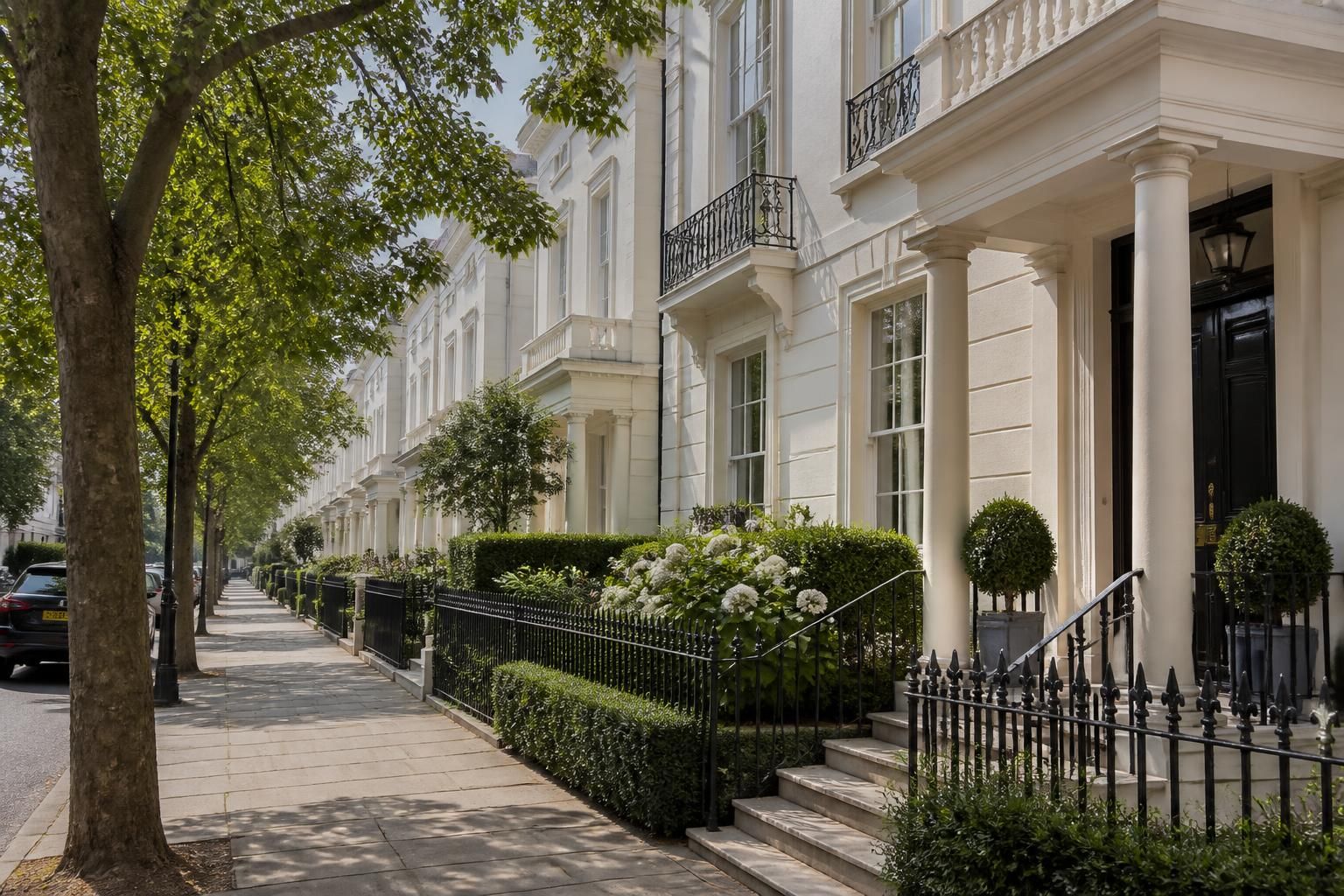 Tree-lined Cheltenham street with elegant period homes.